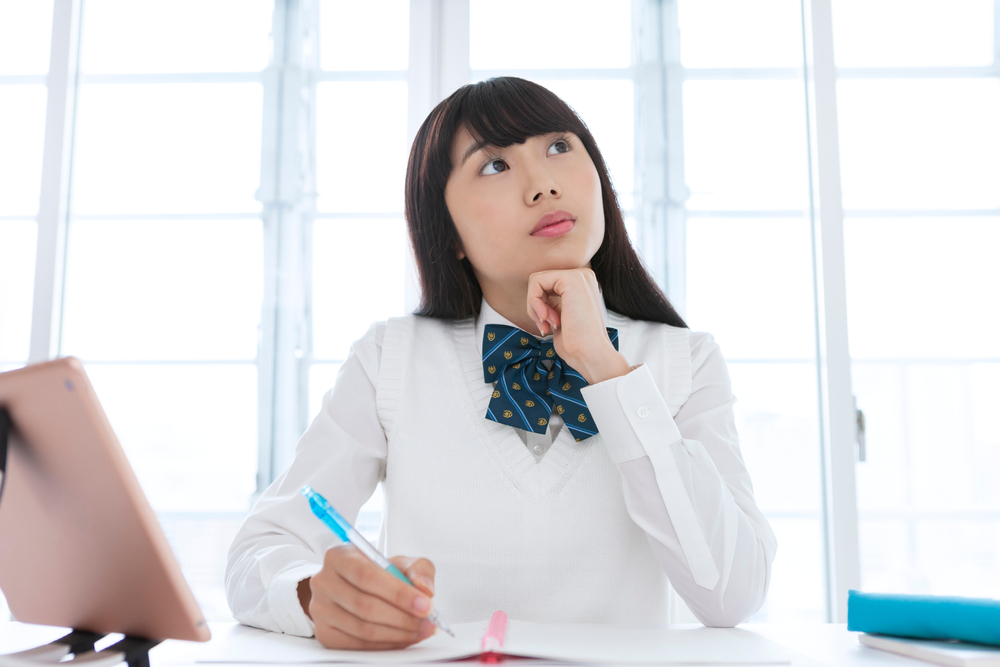 首を傾げる女子生徒